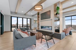a living room with a couch and chairs and a fireplace