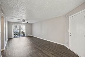 A room with a sliding glass door leading to a balcony.