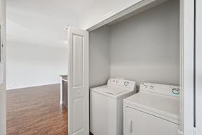 A white washing machine and dryer in a laundry room.