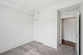 A room with a carpeted floor and white walls.