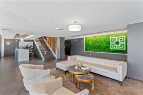 a living room with a white couch and a green wall