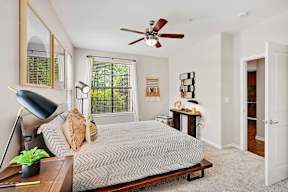a bedroom with a bed and a ceiling fan