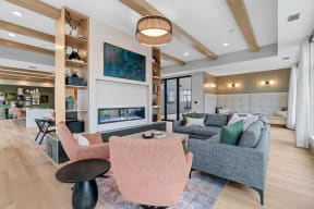 a living room with couches and chairs and a fireplace