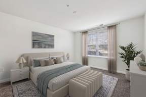 A bedroom with a large bed and a painting on the wall.