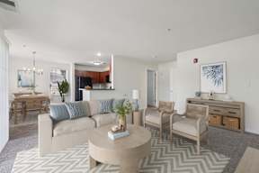 A living room with a couch, chairs, and a coffee table.