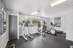 A gym with a sign that says "Don't stop when you're tired, you're done.".