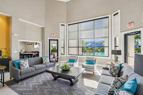 A living room with a grey couch and a coffee table.