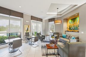 A living room with a grey couch and a brown table.
