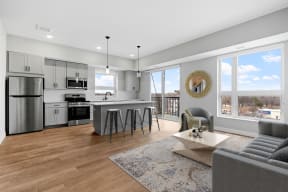 a living room with a kitchen and a couch and a table
