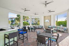 A patio with a table and chairs and a bar area.