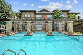 a swimming pool with a house in the background