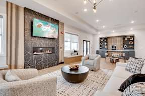 A modern living room with a fireplace and a painting on the wall.