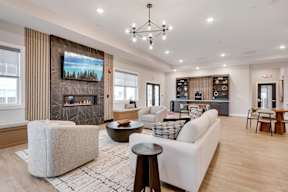 A modern living room with a fireplace and a television.