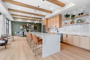 a large kitchen with a large white island and wood floors