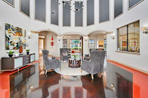 a living room with high ceilings and a table with chairs