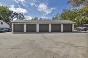 a garage with three garages and a parking lot