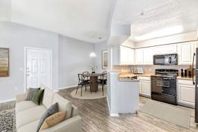 A modern kitchen with a white island and stainless steel appliances.