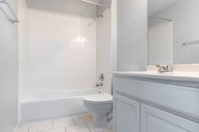 a bathroom with a toilet and a tub and a sink