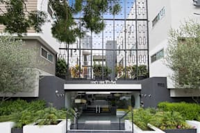 A modern building with a glass entrance and a sign that reads "ninety five fifty five.".