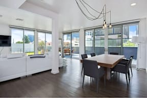 A modern dining room with a wooden table and chairs.