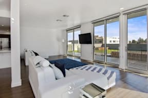 A modern living room with a white sofa and a television.