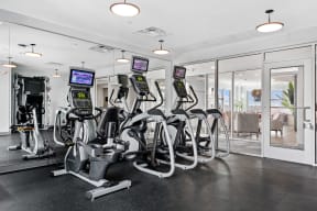 a row of exercise bikes in a gym