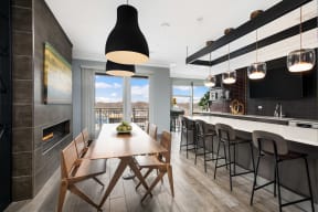 a dining area with a wooden table and chairs and a large window with a view of the