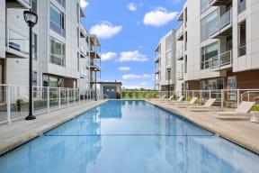a swimming pool in between two apartment buildings