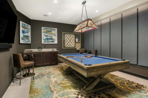 a game room with a pool table and a bar
