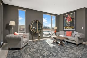 a living room with couches and chairs and a rug