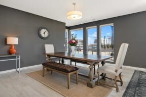 a dining room with a table and chairs and a large window