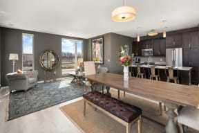 a living room and dining room with a wooden table