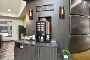 a lobby with a coffee machine and a large refrigerator