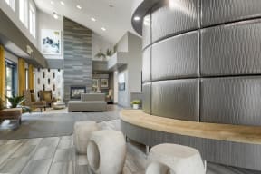 the lobby of a community center with a fireplace and couches