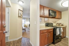 the view of a kitchen with a stove top oven and a microwave