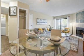 a living room with a glass table and a fireplace