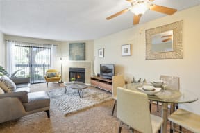 a living room with a table and chairs and a fireplace