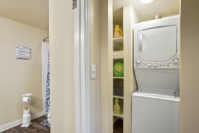 a laundry room with a washer and dryer and a closet