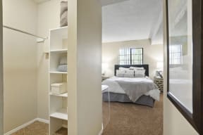 a bedroom with a large bed and a closet