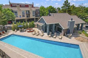 an aerial view of a swimming pool and a house with a pool