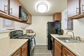 a kitchen with a sink and a stove and a refrigerator