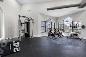 A spacious home gym with a variety of exercise equipment.