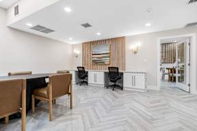 A conference room with a long table and chairs.