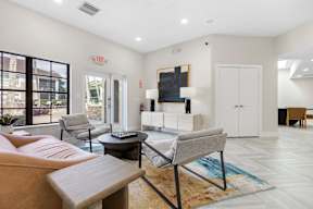 A living room with a couch, chair, and a rug.