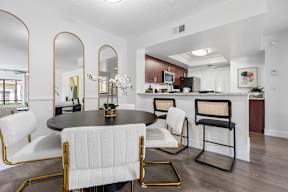 A modern dining room with a round table and chairs.