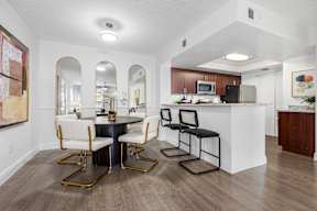 A kitchen with a table and chairs in the middle of the room.