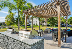 A wooden pergola is over a table with chairs.