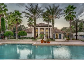 a mansion with a swimming pool and palm trees
