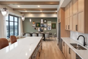 a kitchen with a large island and a table with chairs