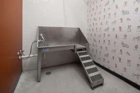a large stainless steel sink in a room with stairs